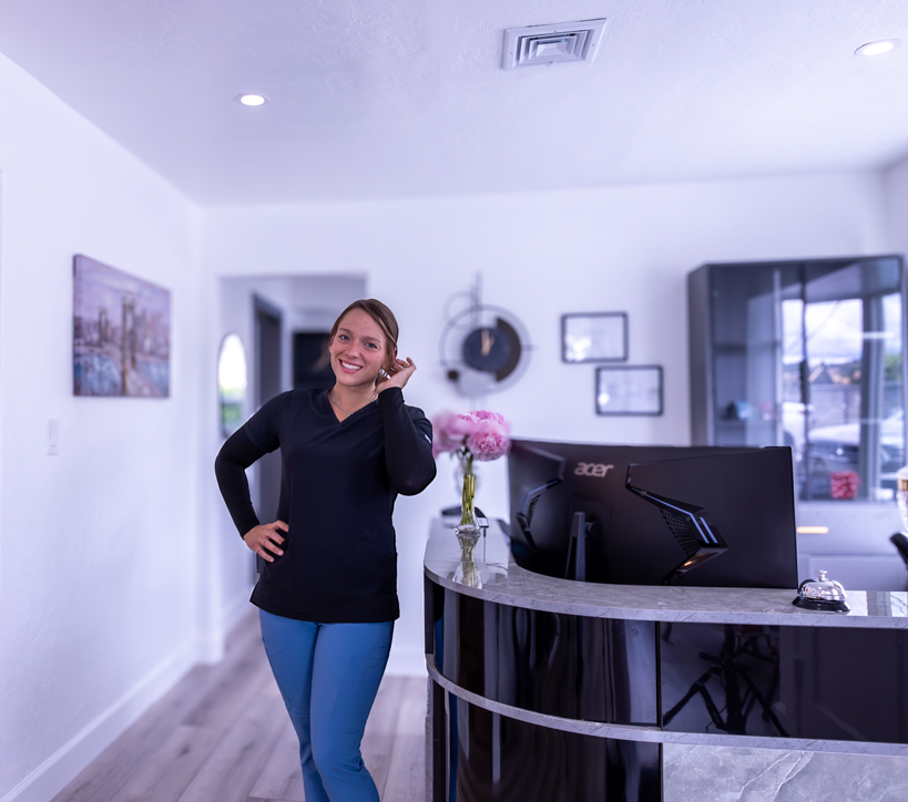 Smiling woman in modern dental office reception area in Roseburg, Oregon.