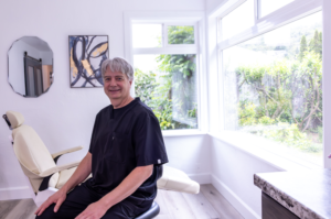 Smiling man Denturist in dental office setting.