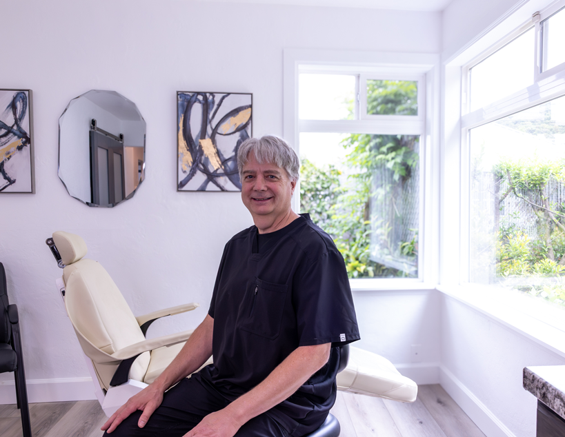 Most affordable dentures in Oregon, Randy Clasen Denturist in Roseburg sitting inside well-lit and inviting treatment room.